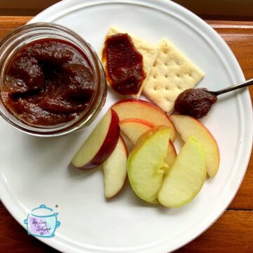 Apple butter, crackers and apple slices on a white plate