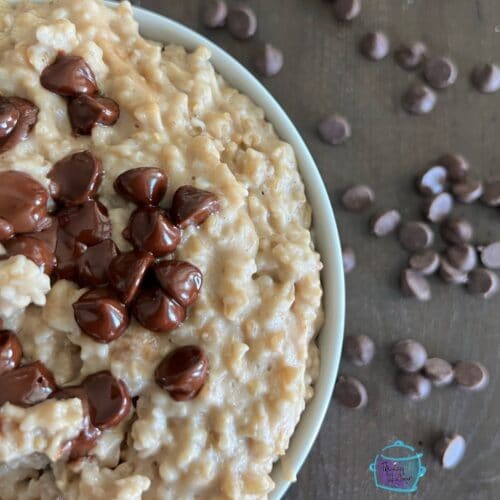 a bowl filled with creamy oatmeal topped with chocolate chips