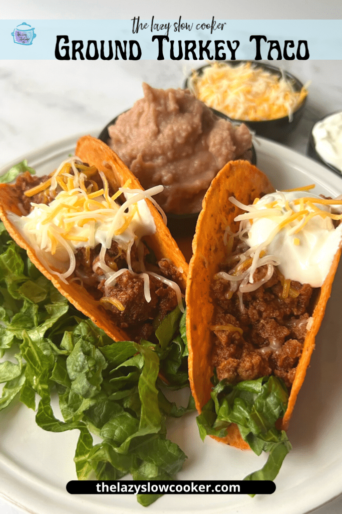two crunchy taco shells filled with ground slow cooker turkey taco