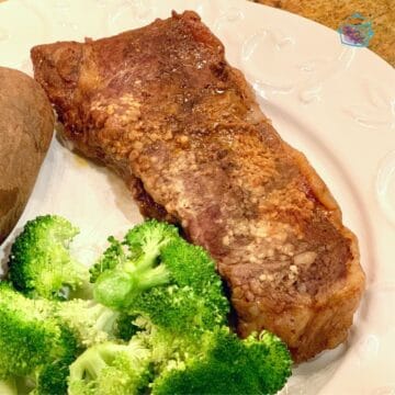 steak with broccoli and potatoes on a white plate