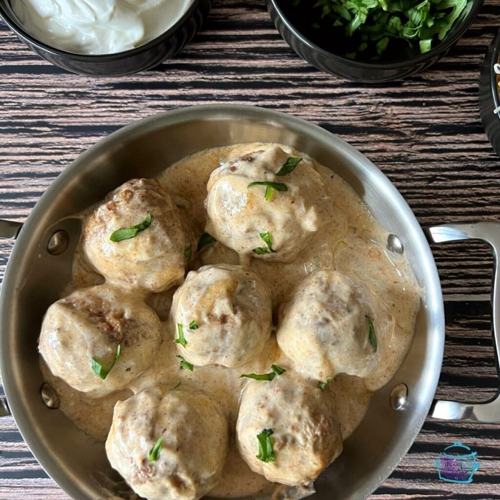 looking down on a creamy pan of enchilada meatballs