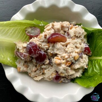 Turkey pine nut and grape salad with leftover crockpot turkey in a round white bowl