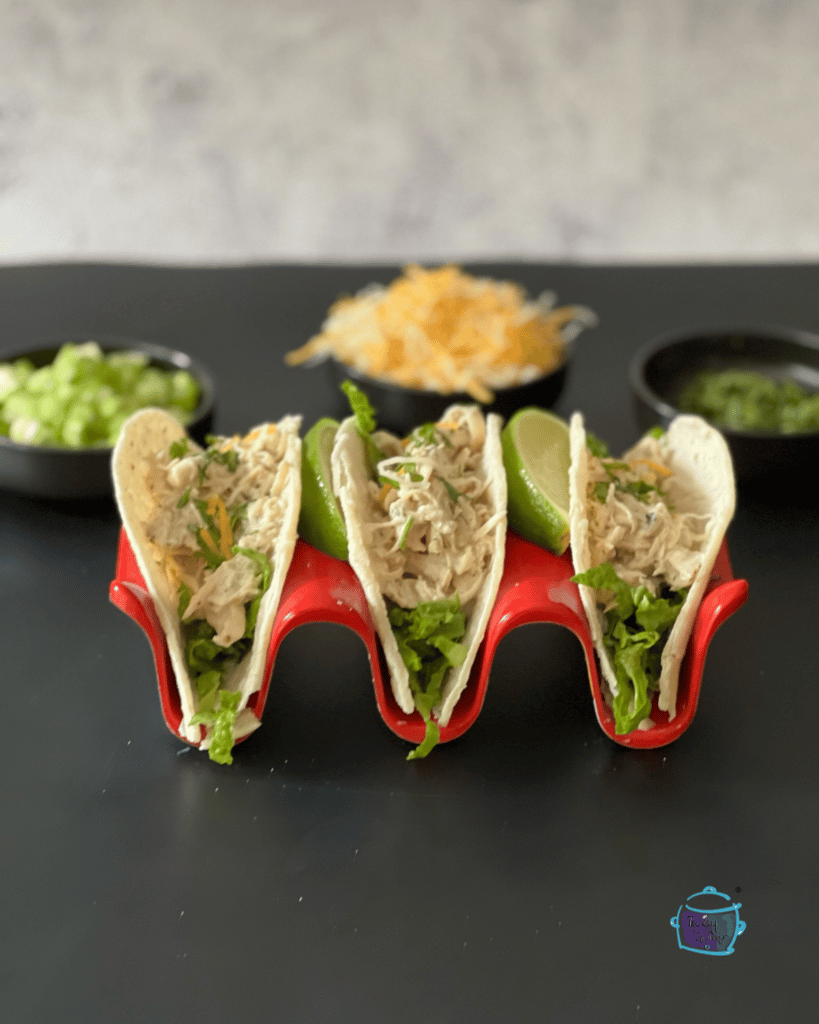 three soft taco shells filled with creamy salsa