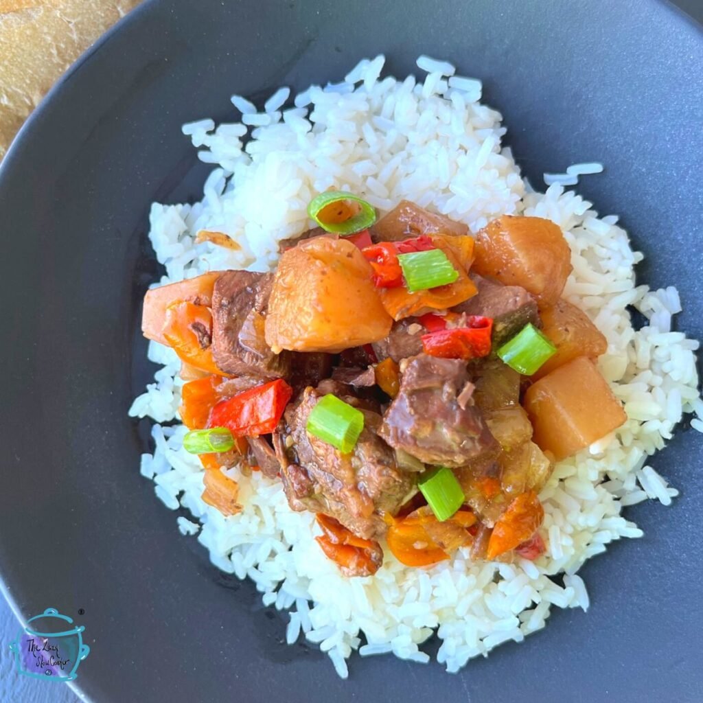 looking down on a dish of beef and pineapple and rice