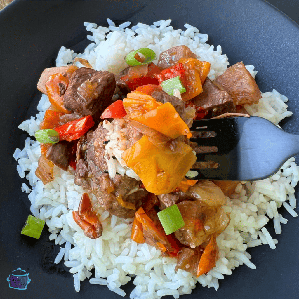 beef and pineapple after it is cooked on a bed of rice