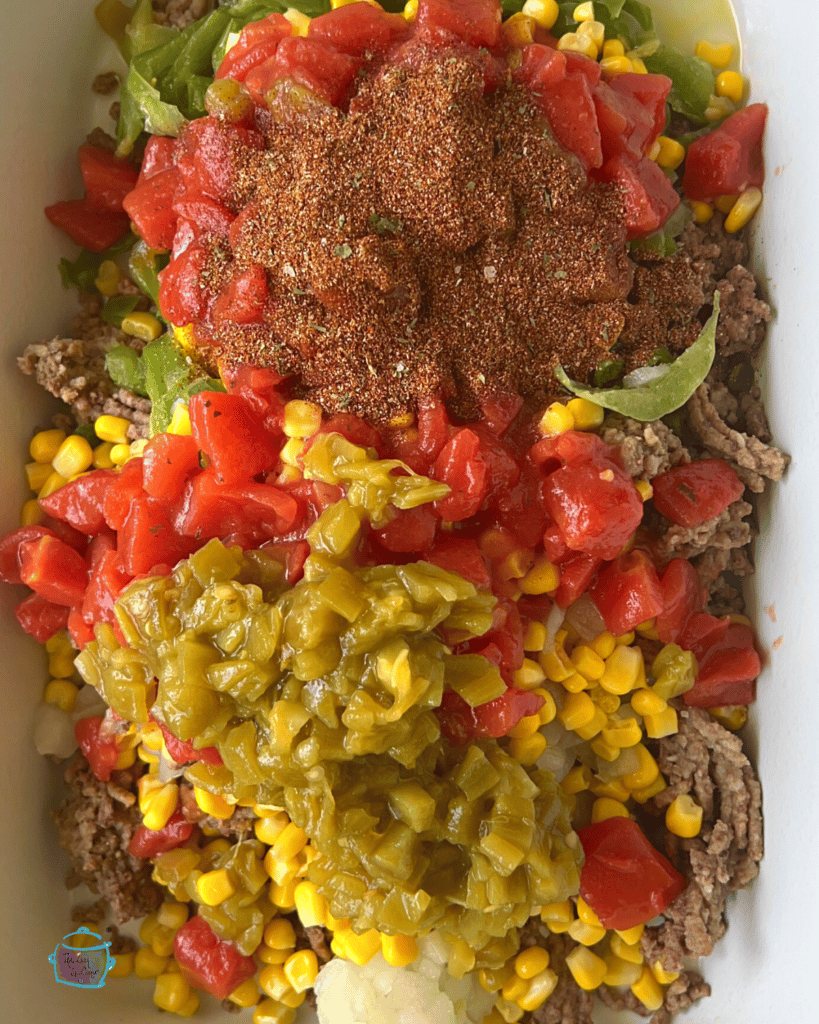 close up of taco pasta ingredients in slow cooker before cooking