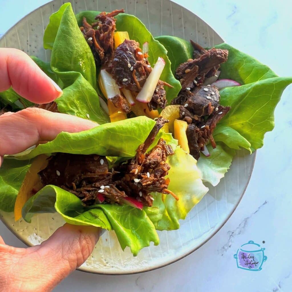 slow cooker beef lettuce cup being held im a hand