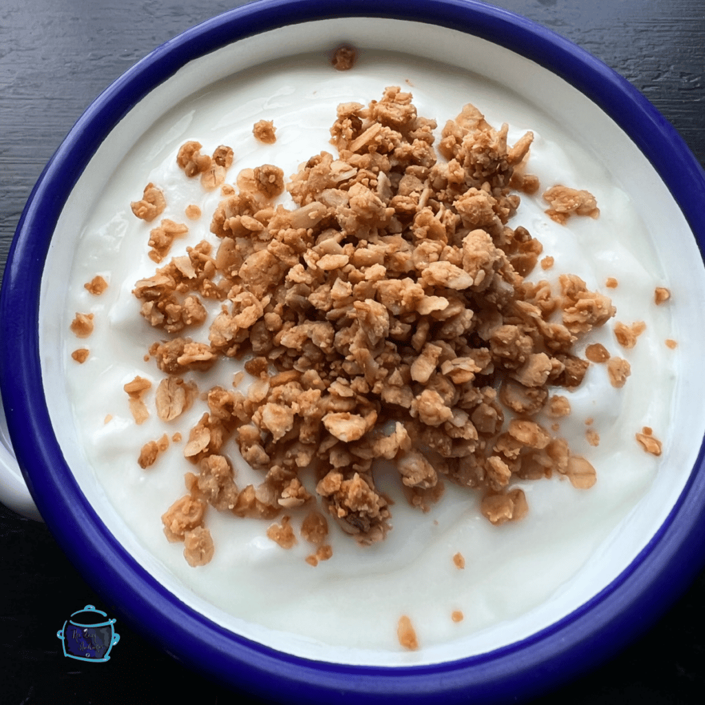 slow cooker peanut butter granola on top of yogurt