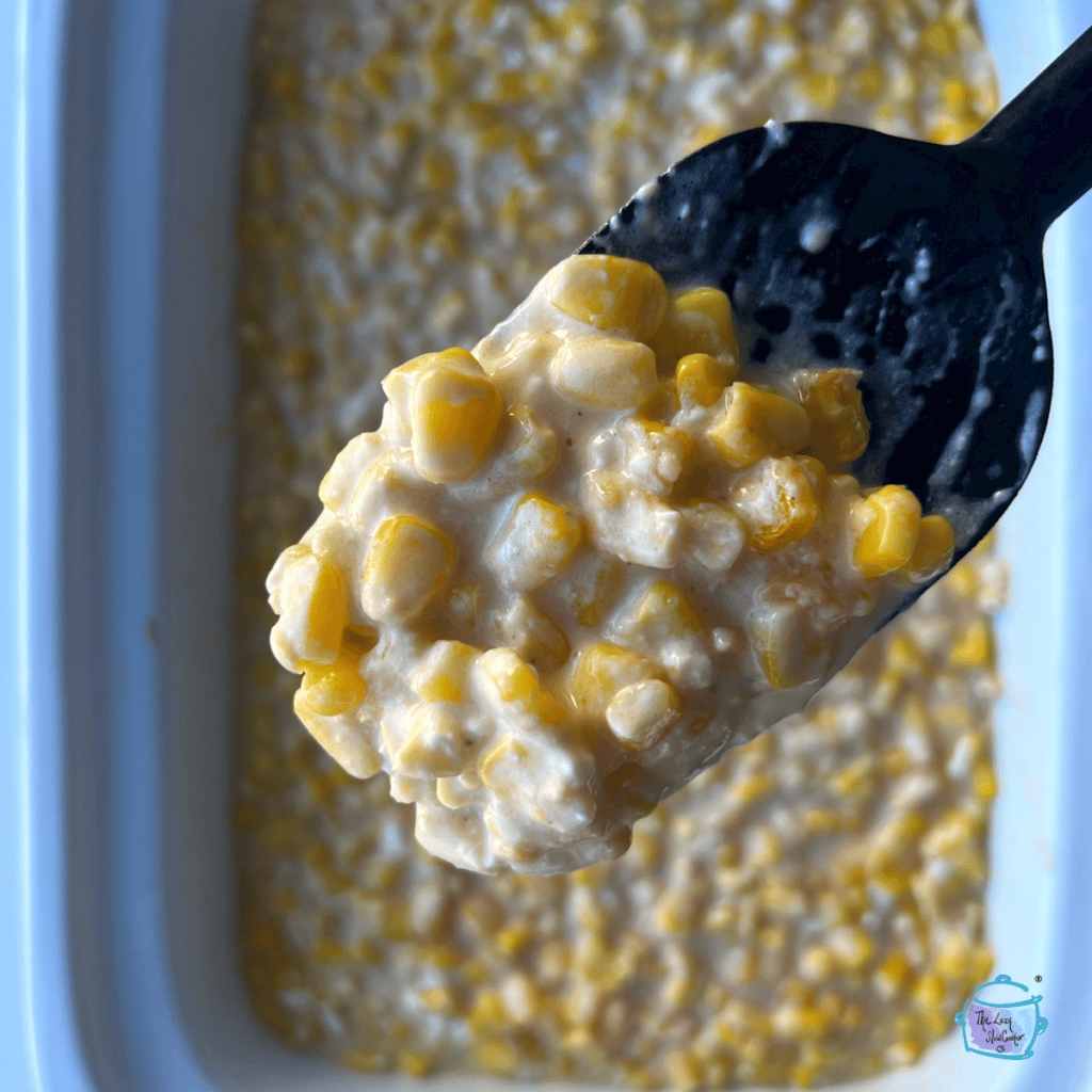 Finished corn on a mixing spoon held over slow cooker full of the same