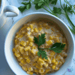 Bowl of creamed slow cooker cheddar corn ready to serve