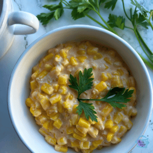 Bowl of creamed slow cooker cheddar corn ready to serve