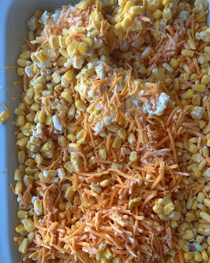 All cheddar corn ingredients in slow cooker before cooking