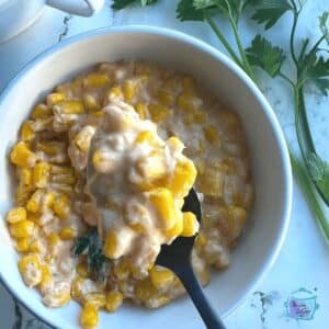 finished creamed corn in a white bowl