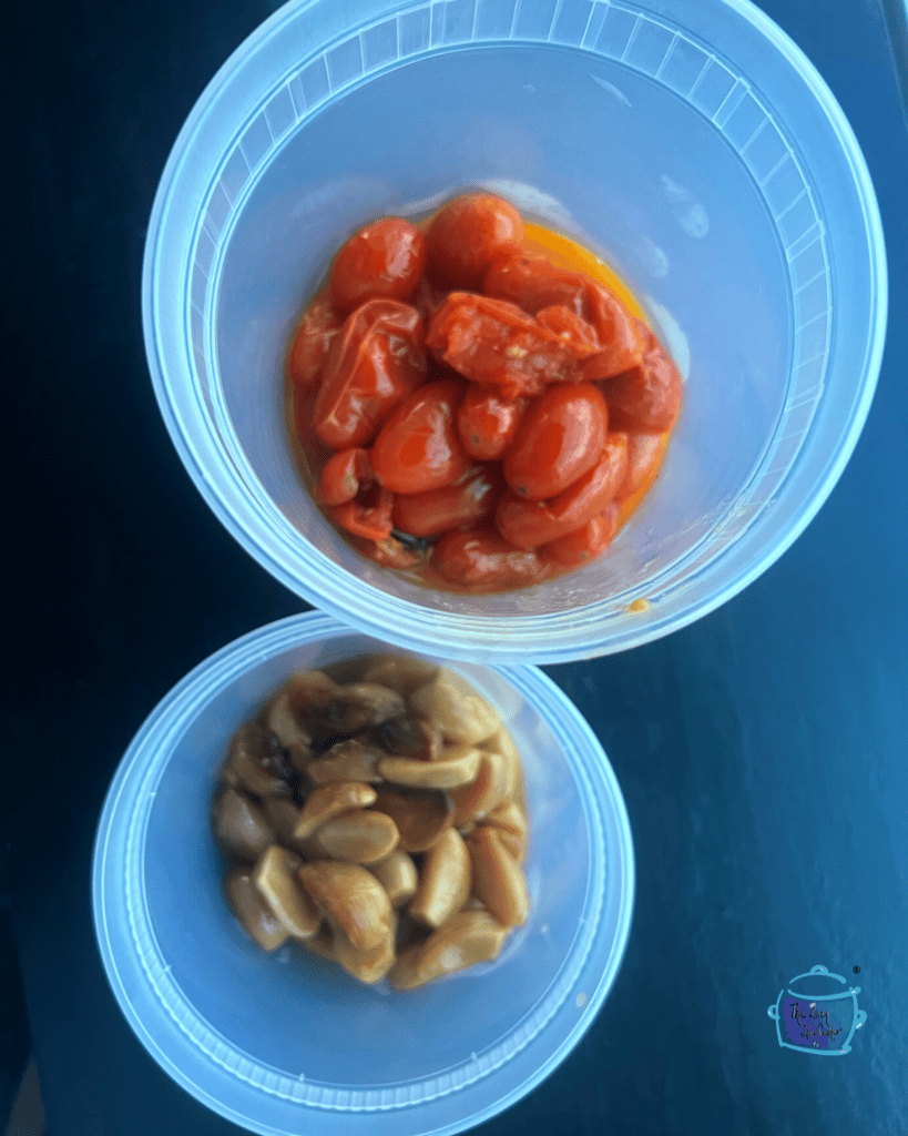 slow cooked tomatoes and garlic is airtight containers before lid is added