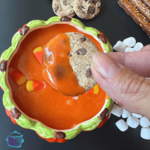 a chocolate chip cooked covered with candy corn dip halloween dessert dip