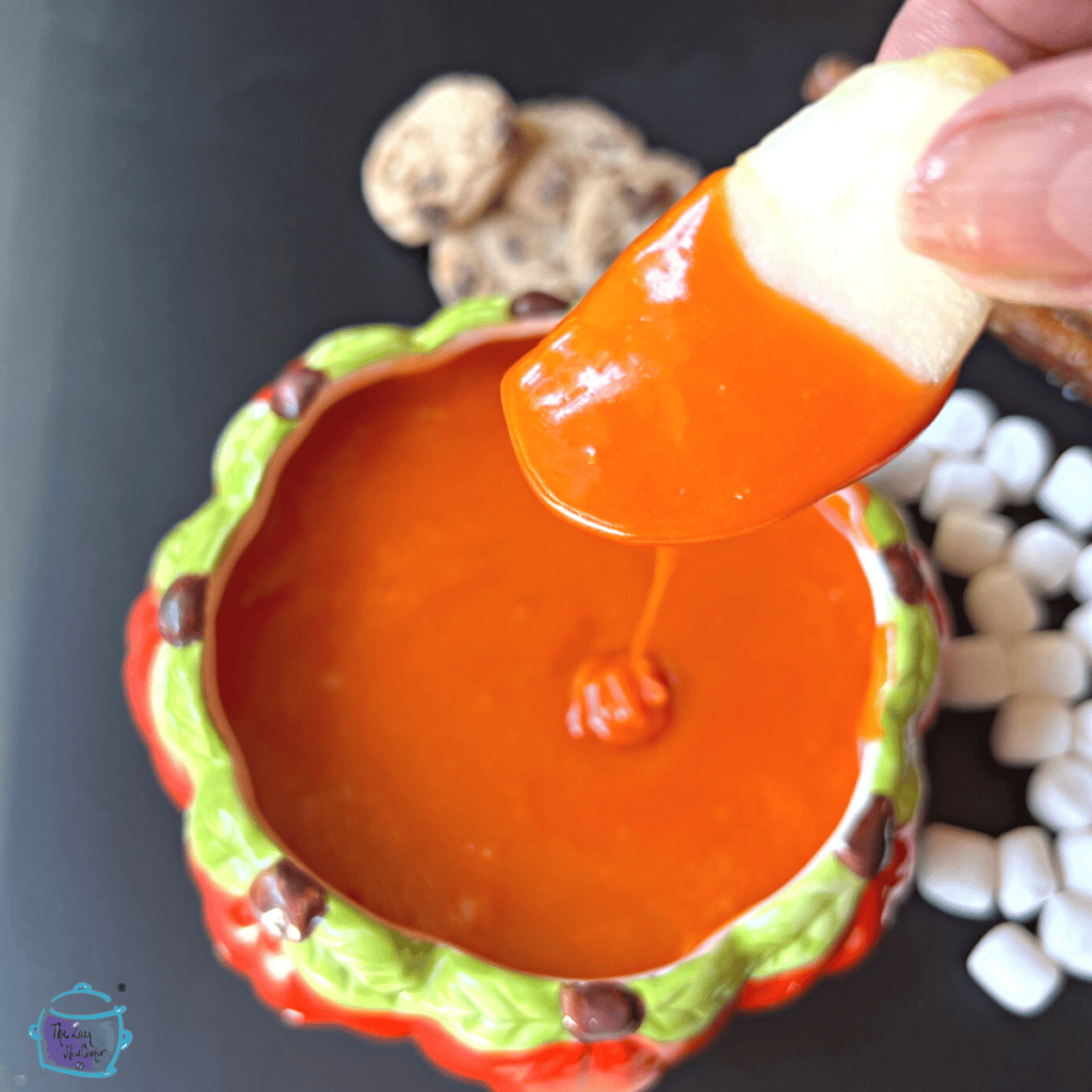 apple sliced coated in slow cooker candy corn dip