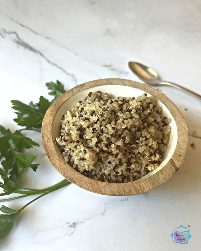 quinoa that was made in a slow cooker displayed in a wooden bowl 