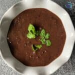 a bowl full of crockpot black bean soup in a bowl ready to serve