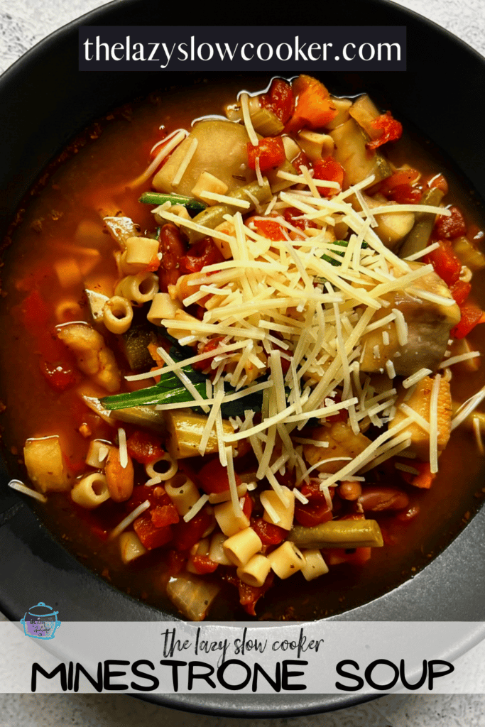 top view of a bowl of minestrone soup after cooking topped with shredded cheddar