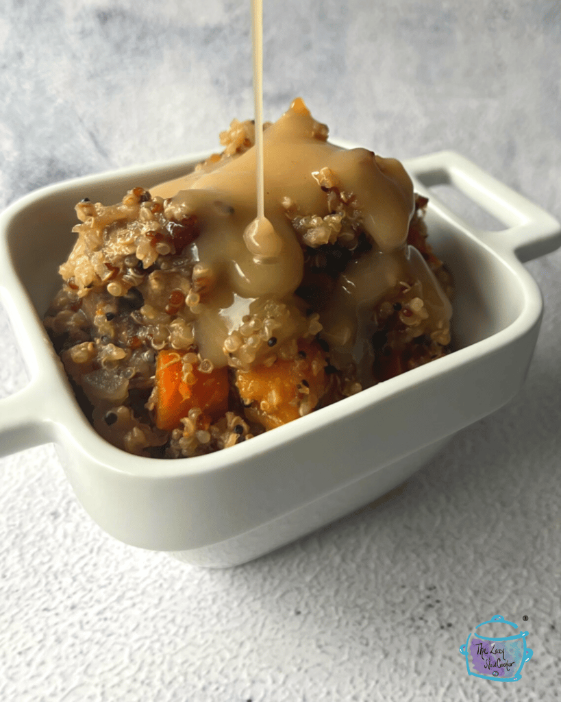 a side view of crockpot quinoa with gravy being poured over it