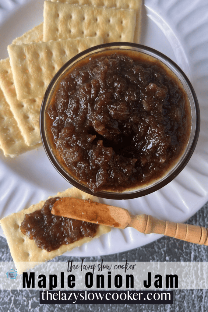 maple onion jam after finished slow cooking in a bowl with crackers and a wooden spreading knife