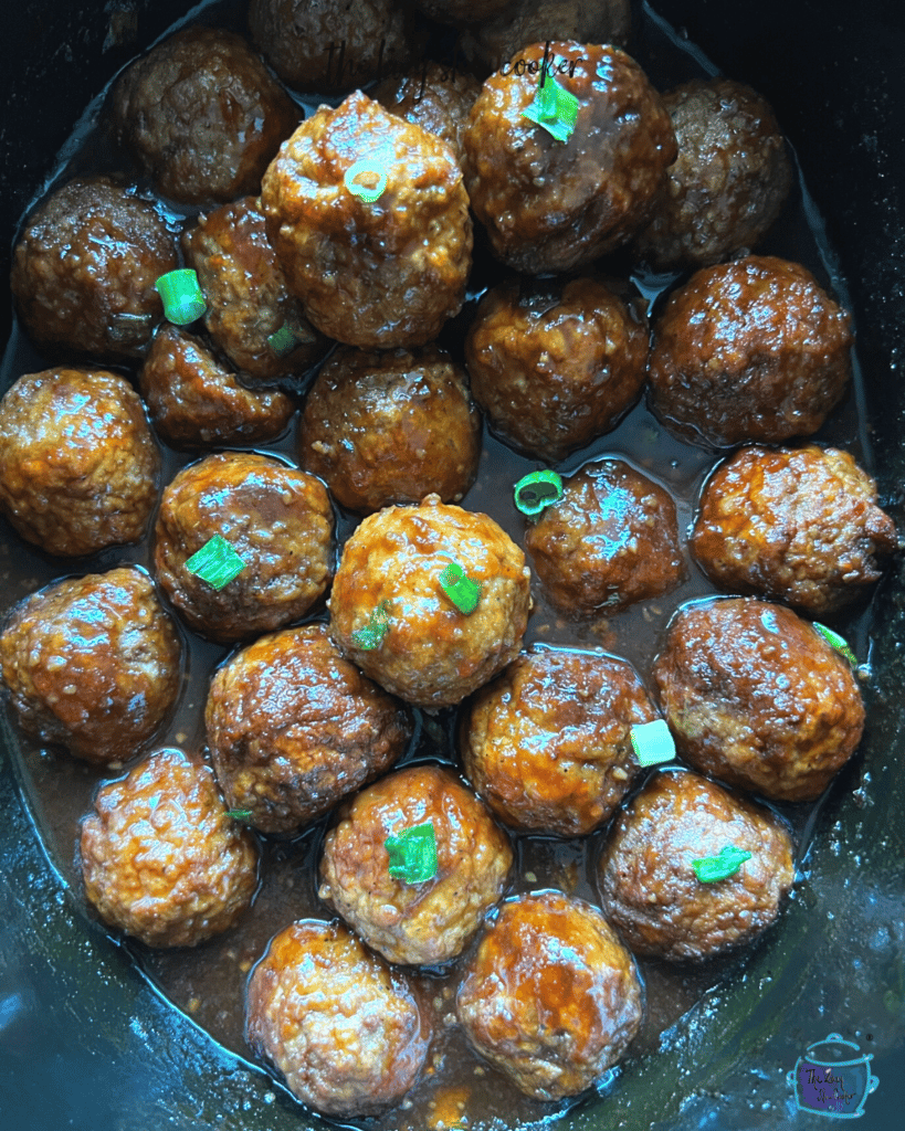 Cooked honey bourbon meatballs still in a slow cooker
