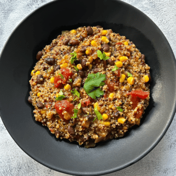 looking down on a black bowl filled with slow cooker mexican quinoa