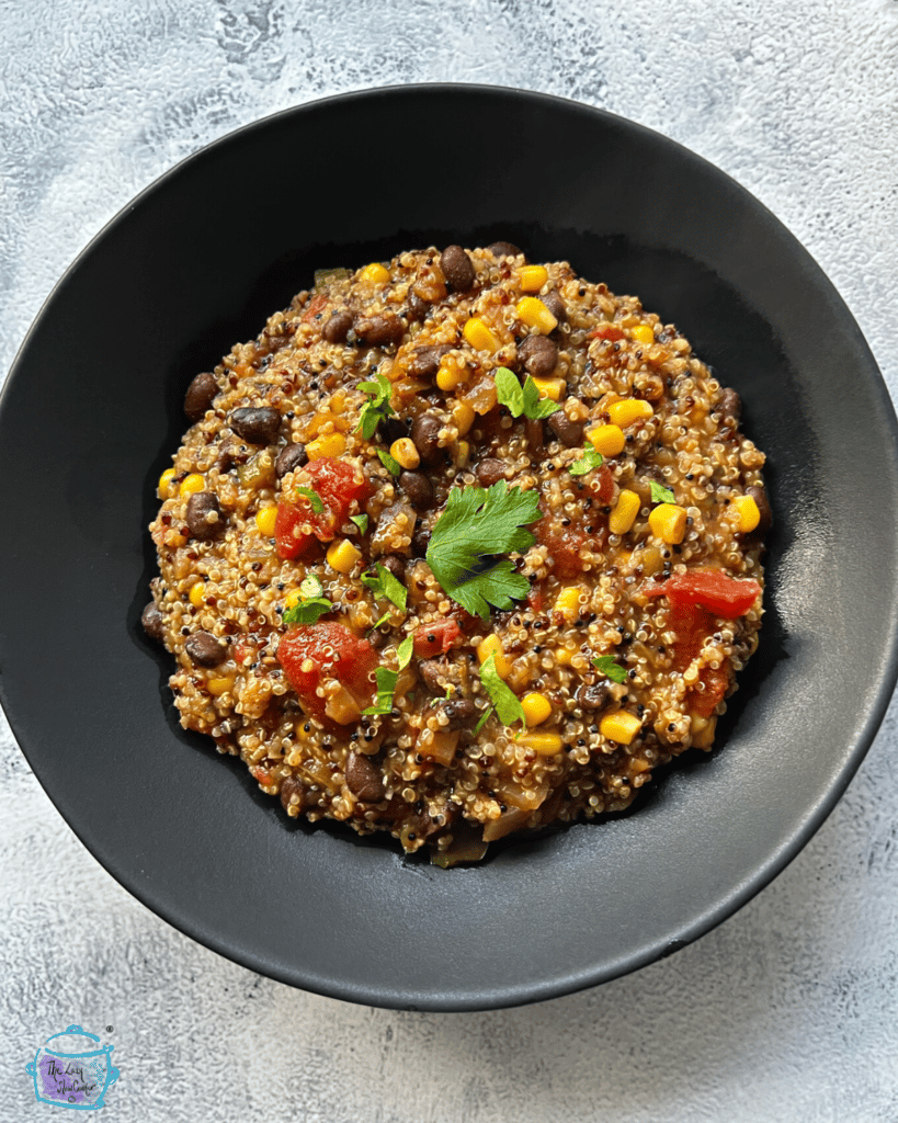 looking down on a black bowl filled with slow cooker mexican quinoa