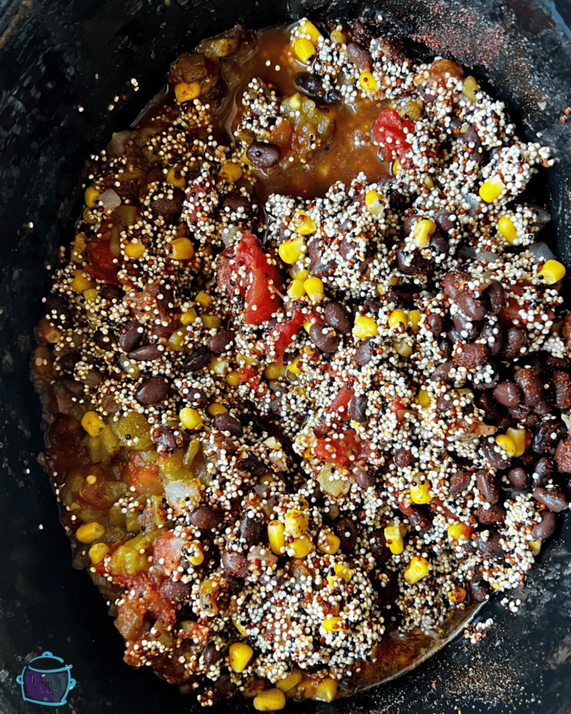 A slow cooker filled with Mexican quinoa before cooking