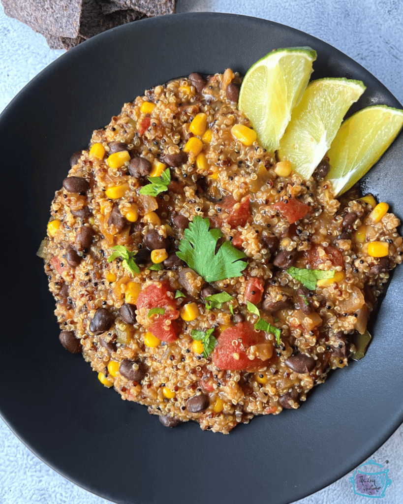 looking down on a black bowl filled with slow cooker mexican quinoa
