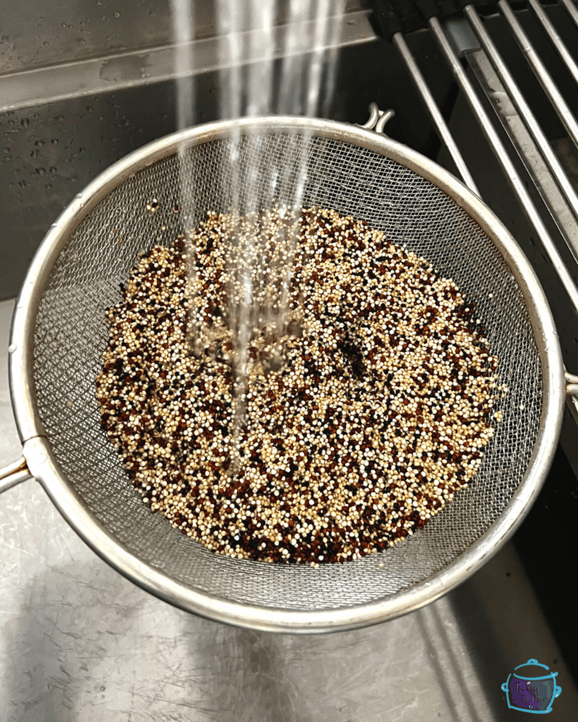 quinoa in a strainer being rinsed. 