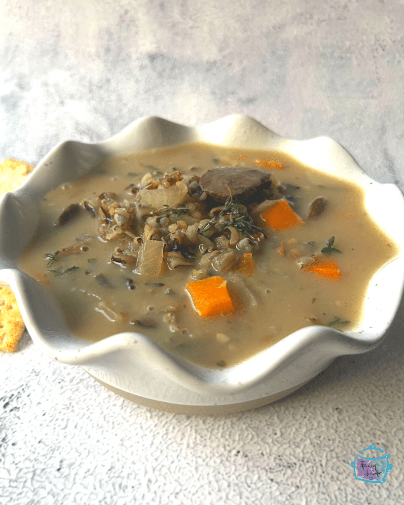 side view of a bowl of wild rice and mushroom soup after slow cooking