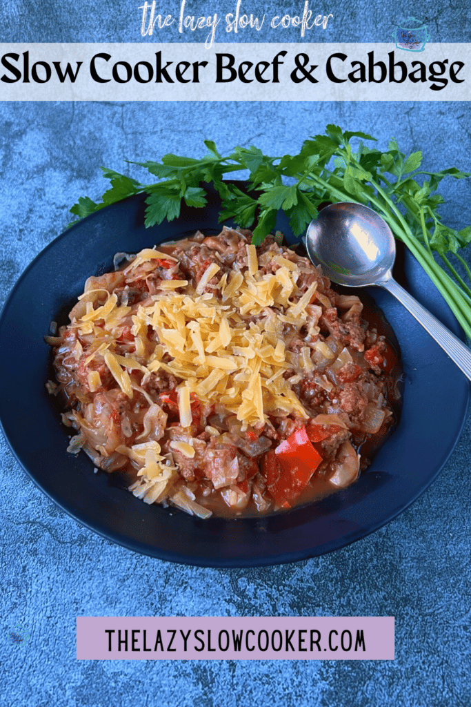 crockpot beef, cabbage and cheese in a black bowl with a spoon
