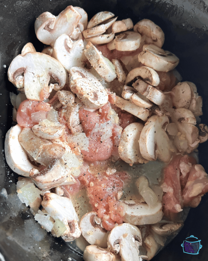 mushrooms and chicken in slow cooker before cooking