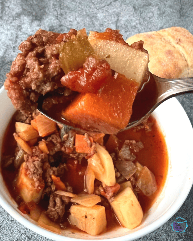 ground beef slow cooker stew close up on a spoon