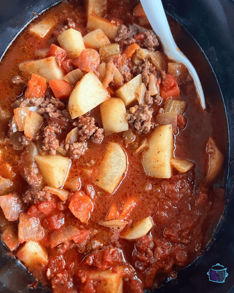 A slow cooker filled with hamburger stew