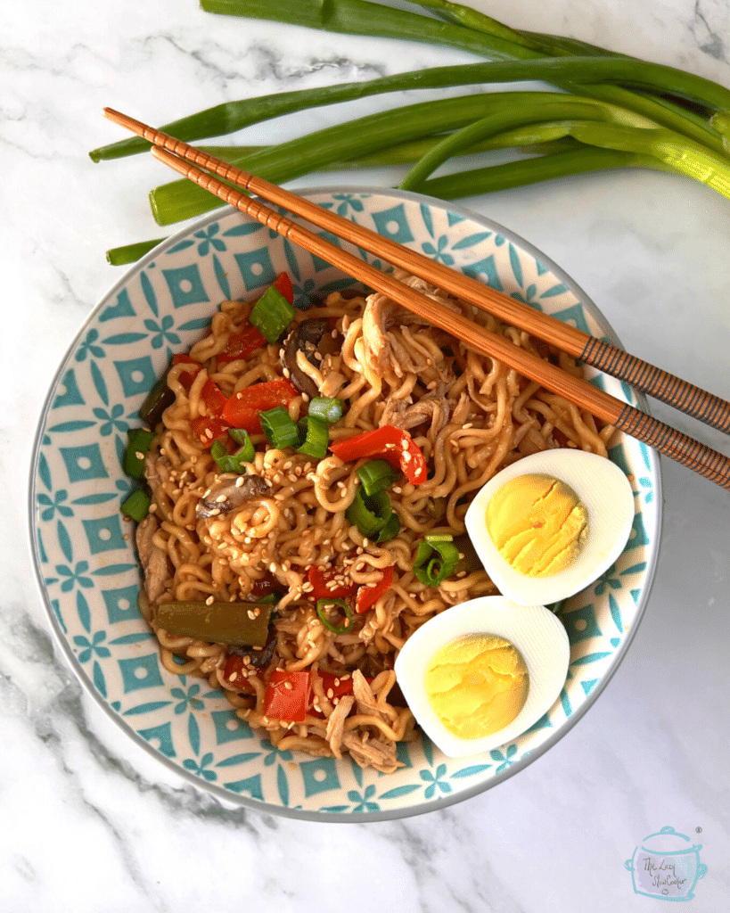 slow cooker ramen noodle with chicken in a bowl with chopsticks