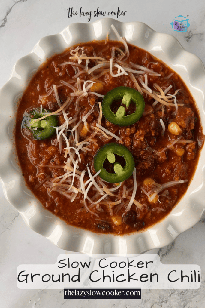 a bowl full of slow cooker ground chicken chili with sliced jalapenos