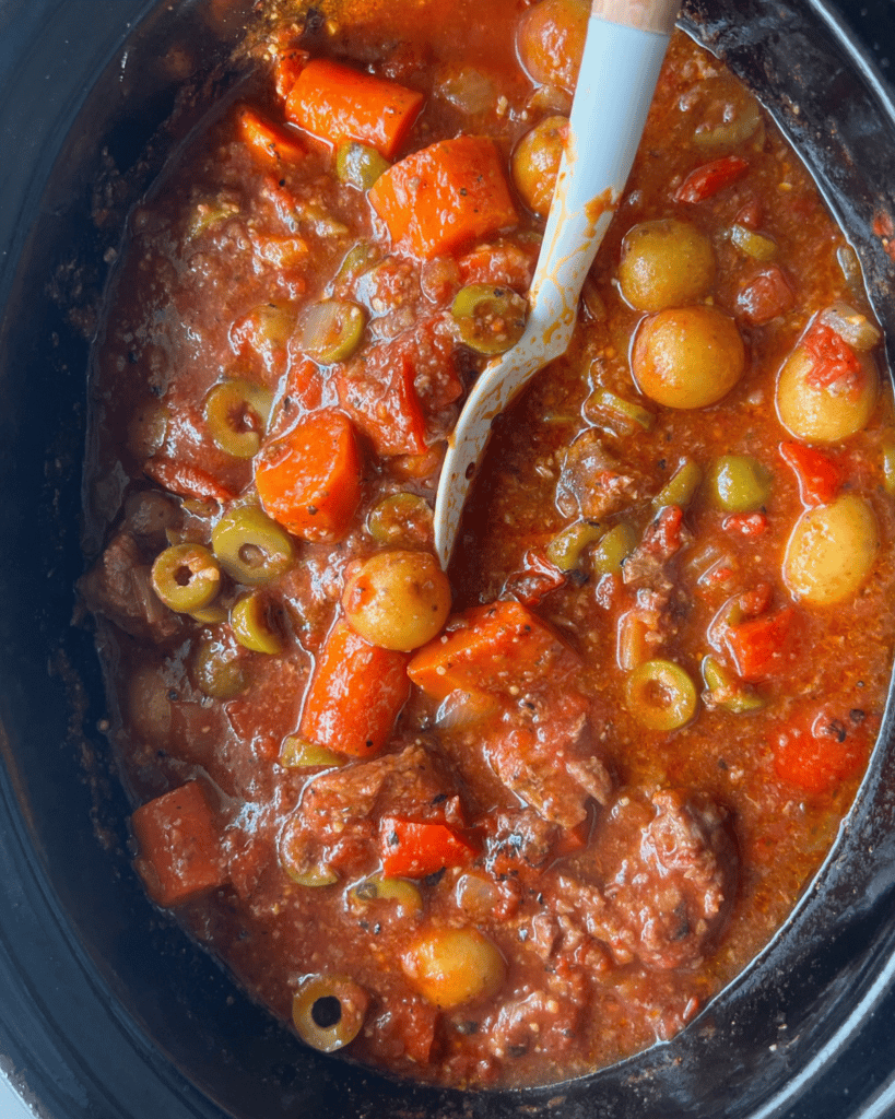 spanish beef stew in a slow cooker ready to serve