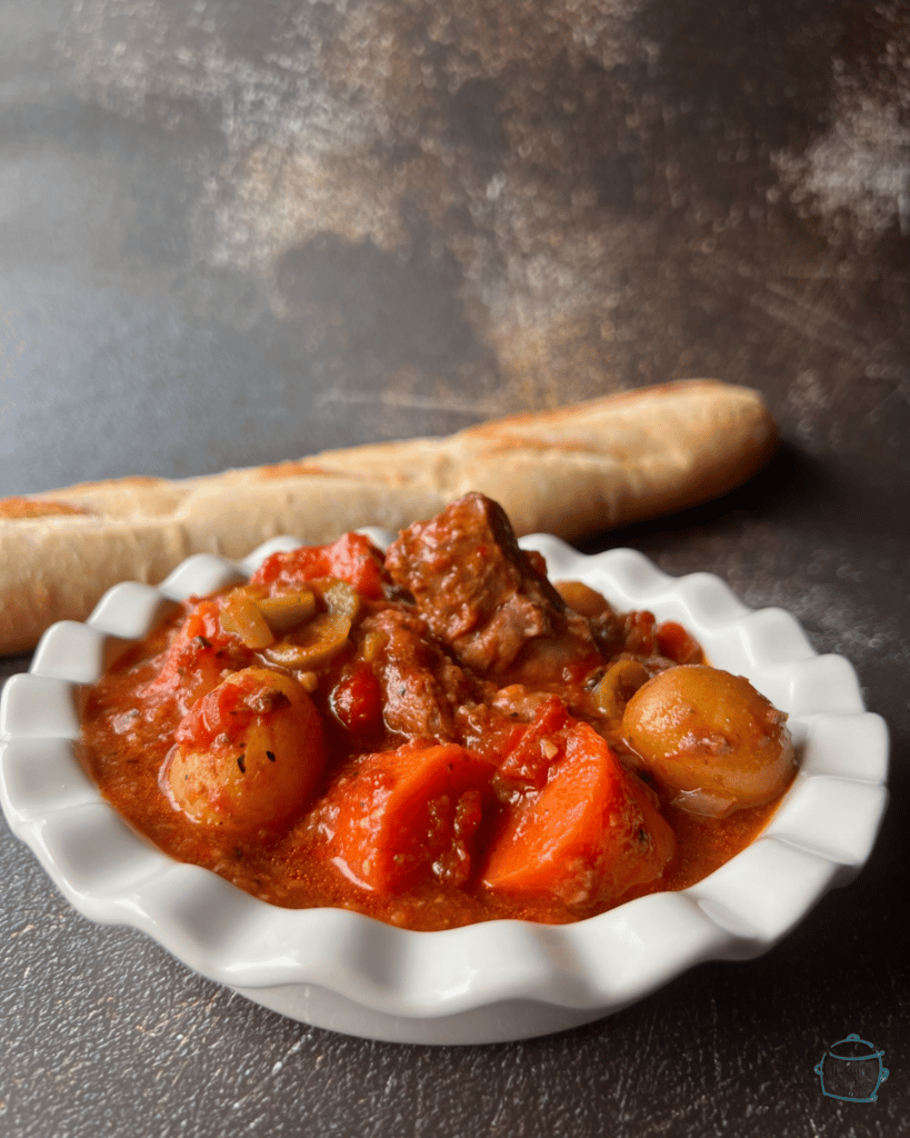 close up of a white bowl containing crockpot Spanish beef and veggie stew