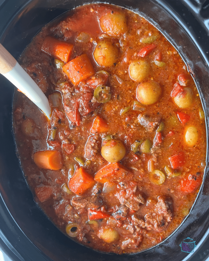 spanish beef stew in a slow cooker ready to serve