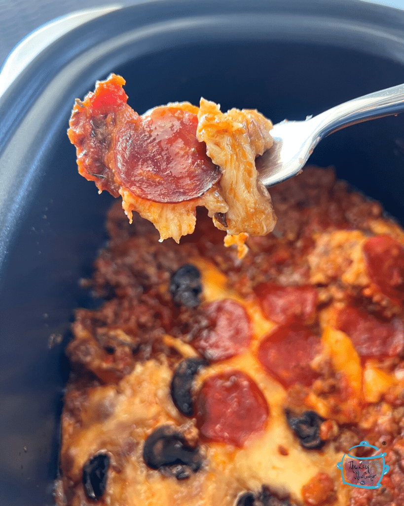 crustless pizza on a spoon over a slow cooker