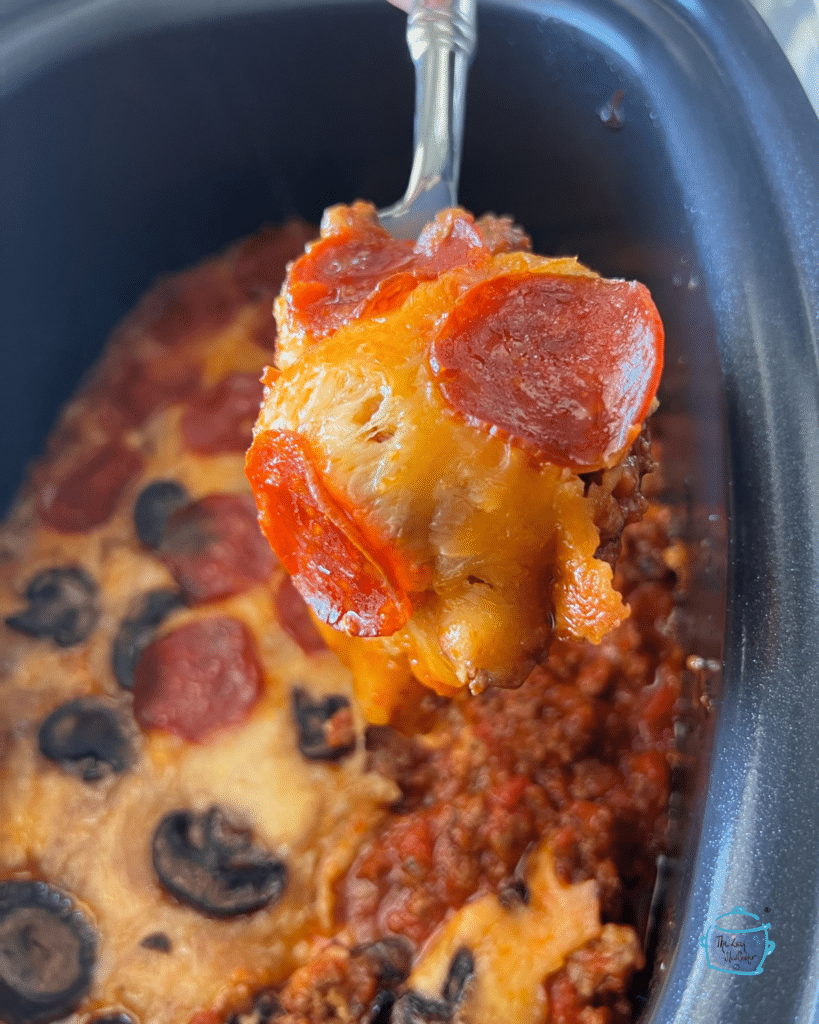 crustless pizza on a spoon over a slow cooker