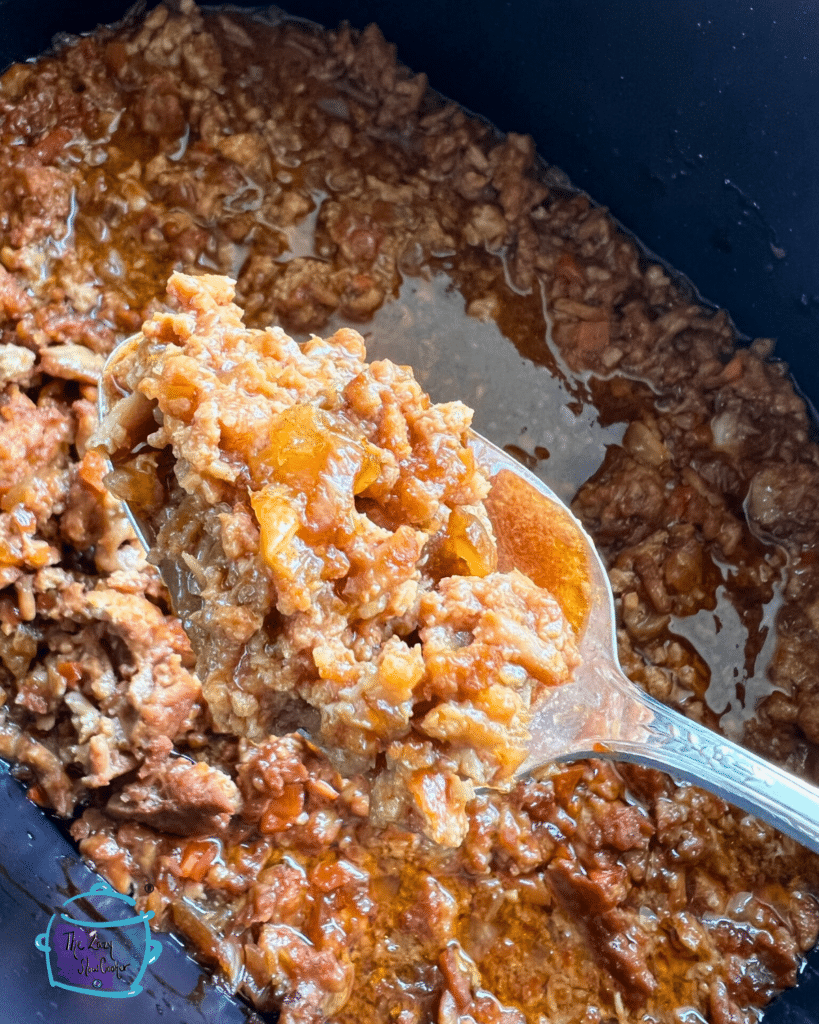 sloppy buffalo joe held on a spoon over a crockpot