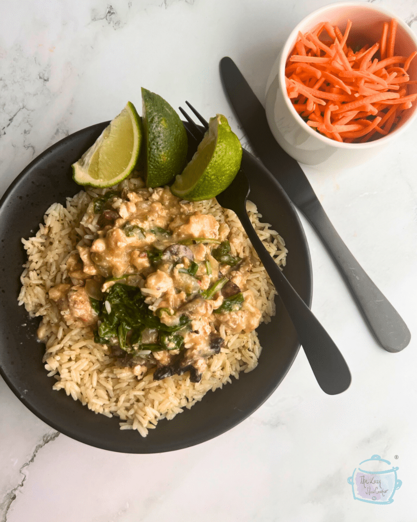 Turkey spinach and pepper jack cheese casserole in a black bowl with a fork