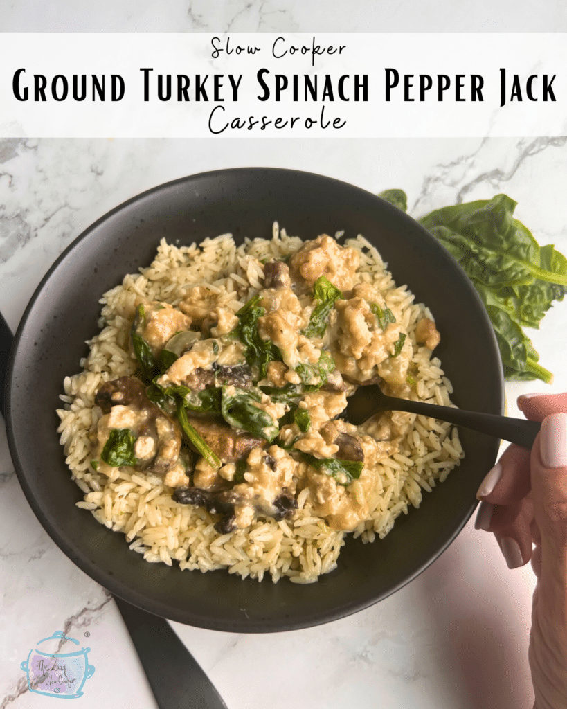 Turkey spinach and pepper jack cheese casserole in a black bowl with a fork