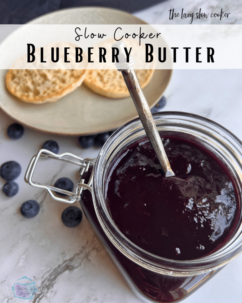 a container of thick looking blueberry butter with a knife in it and two slices of English muffin