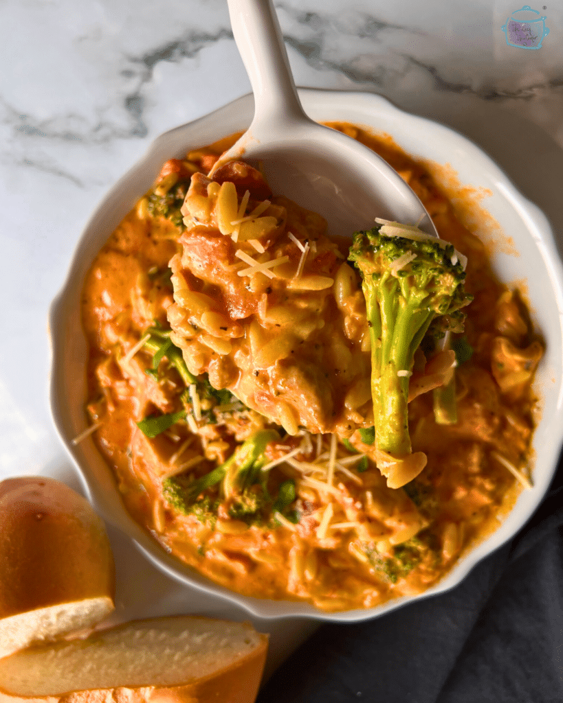 chicken orzo in blush sauce on a spoon 