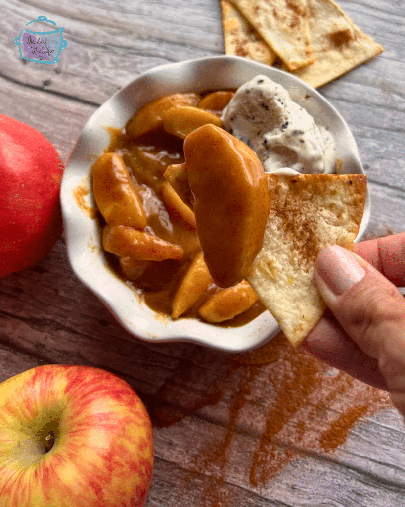 slow cooker caramel apple pie filling on a toasted cinnamon tortilla chip