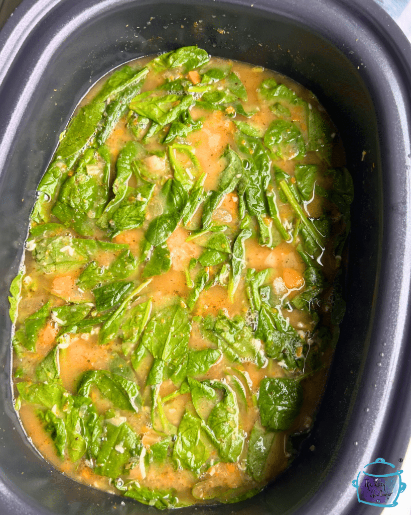white bean and spinach soup in slow cooker after cooking